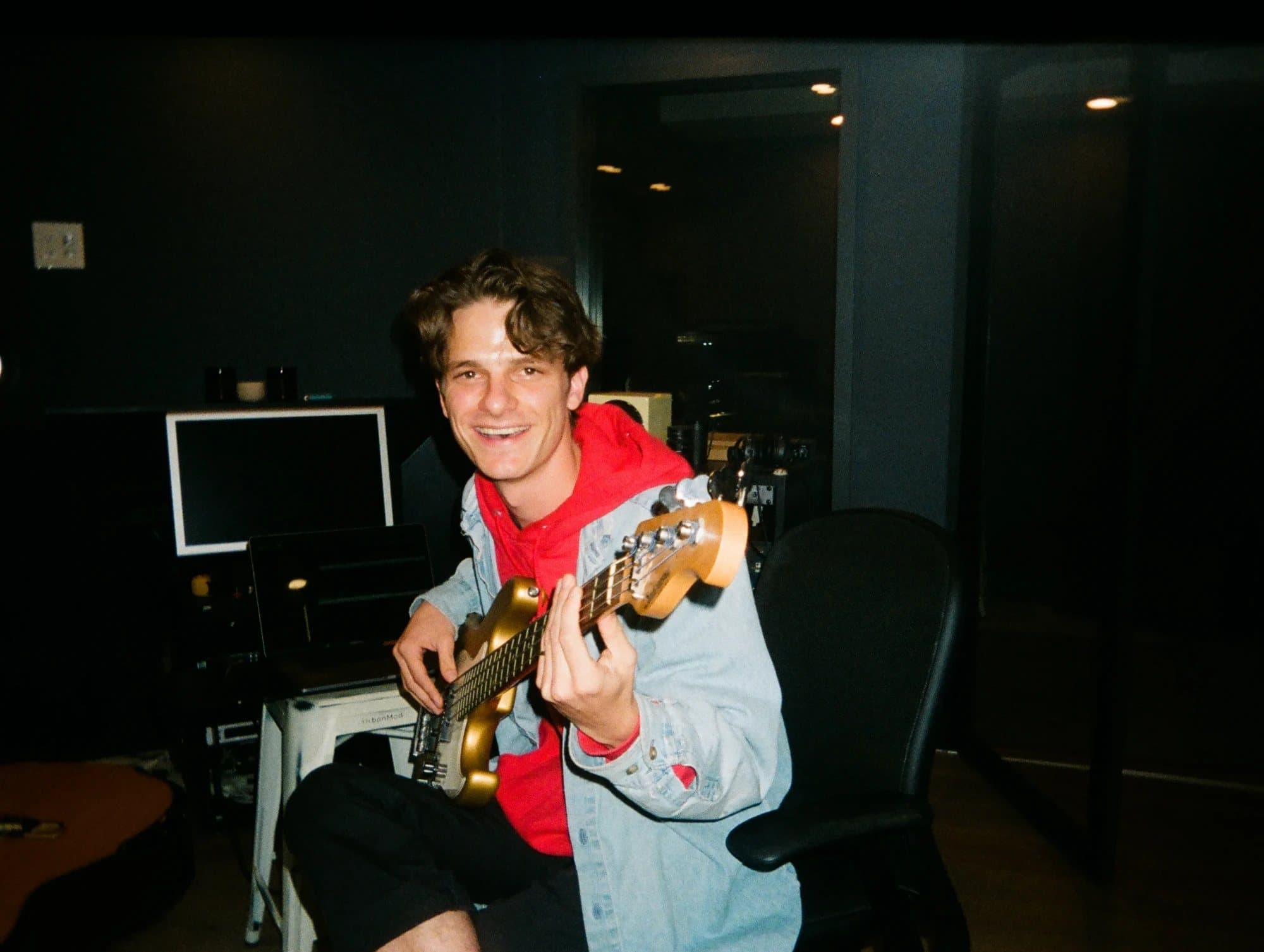 Michael laughing with a bass in the studio